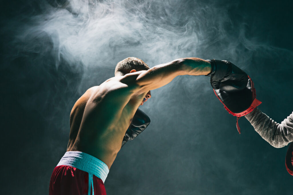 muscular-man-boxing-with-punching-mitts-in-studio-2026-04-13-00-33-47-utc